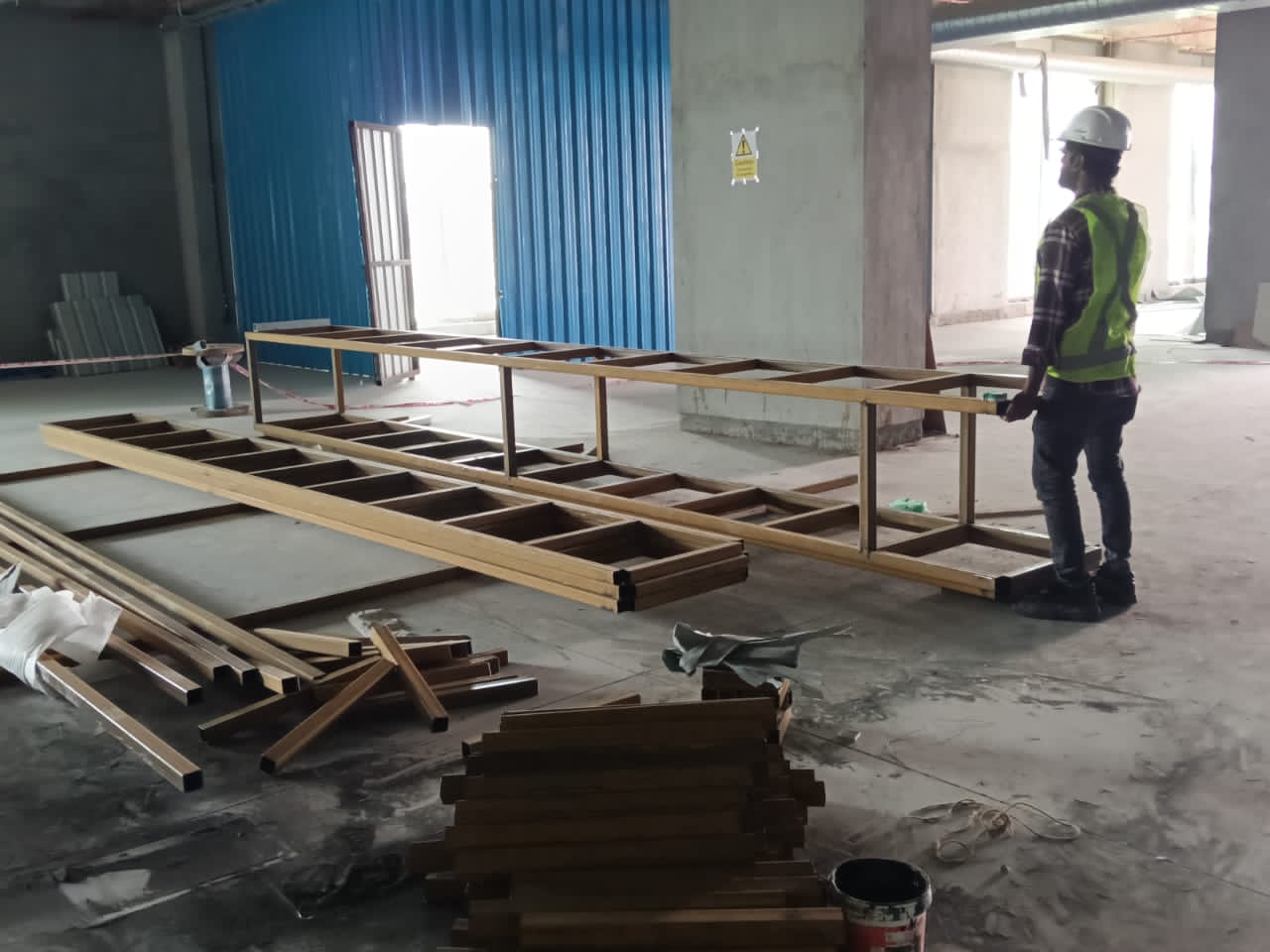 Metal planter framework laid out for fabrication inside the site